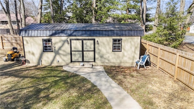 view of outdoor structure featuring an outbuilding and a fenced backyard