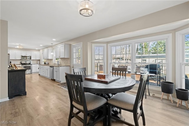 dining space with recessed lighting, baseboards, plenty of natural light, and light wood-style flooring