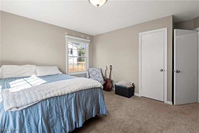 bedroom with baseboards and carpet