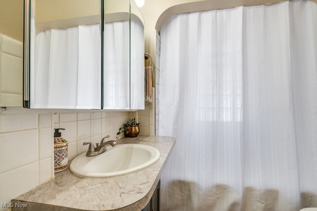 bathroom featuring backsplash and vanity