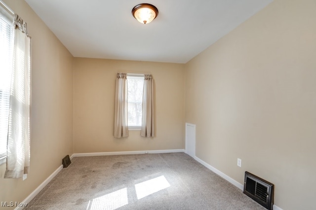 carpeted empty room with baseboards and visible vents