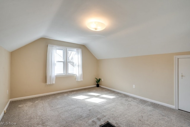 bonus room featuring carpet flooring, baseboards, and vaulted ceiling