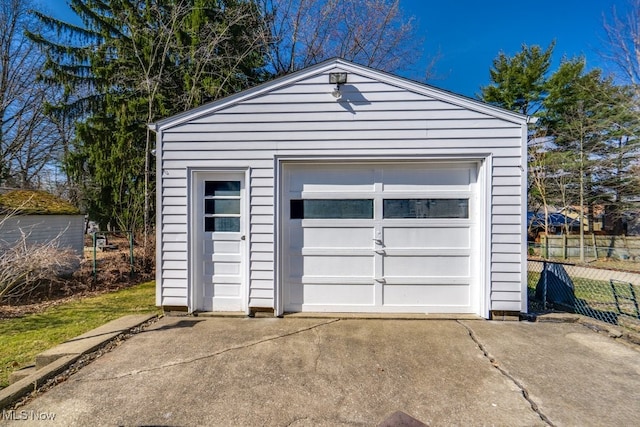 detached garage with driveway and fence