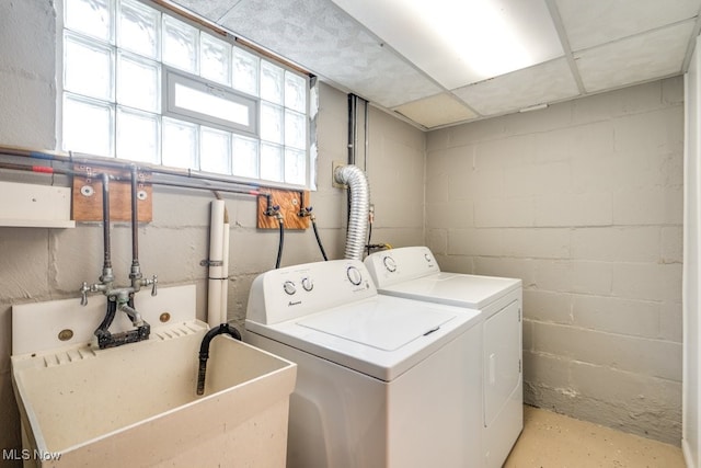 laundry room with washer and dryer, laundry area, and a sink