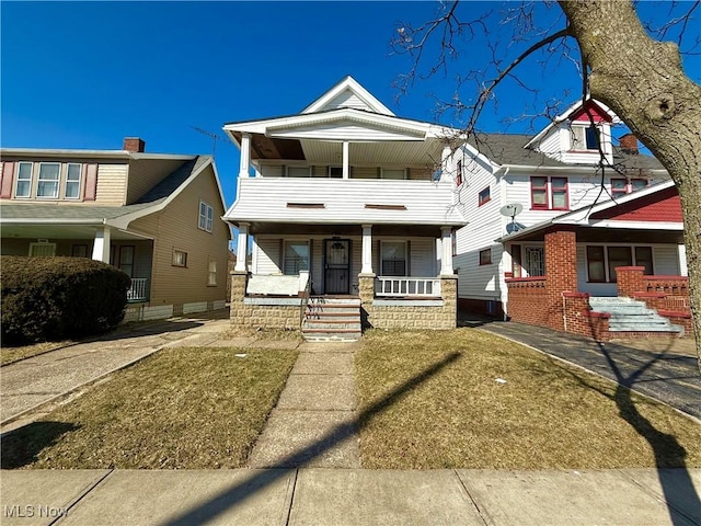 view of front of property with covered porch and a balcony