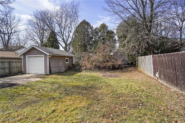 view of yard with an outdoor structure, fence, a garage, and driveway