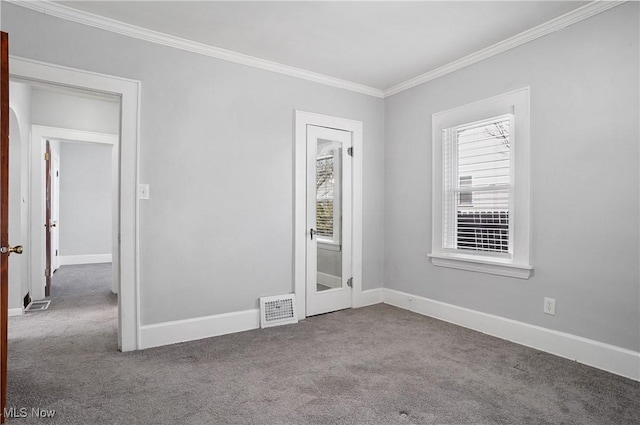 unfurnished bedroom with visible vents, multiple windows, carpet floors, and crown molding