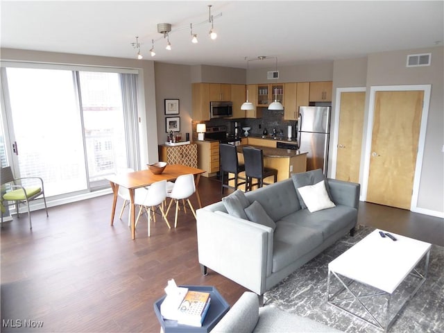 living room with visible vents and dark wood-style floors