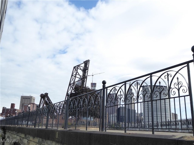 view of gate featuring a view of city and fence