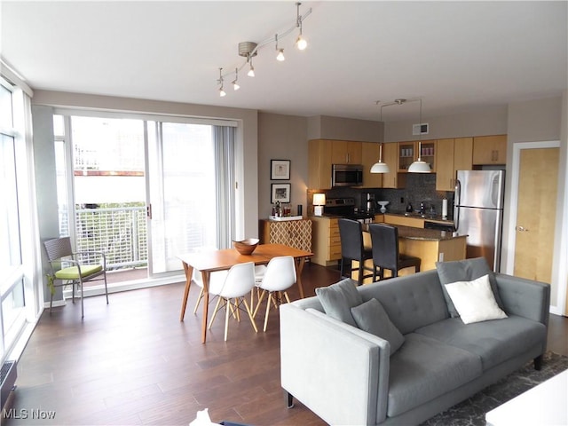 living area featuring visible vents and dark wood-style flooring