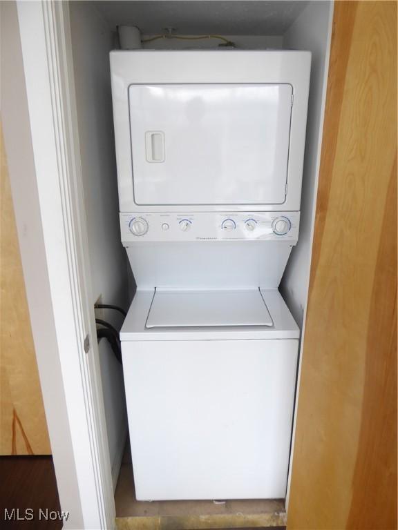 laundry room featuring stacked washer and dryer and laundry area