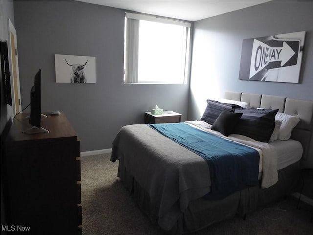 carpeted bedroom featuring baseboards