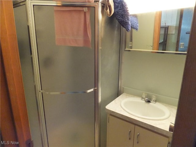 full bathroom with vanity and a shower stall