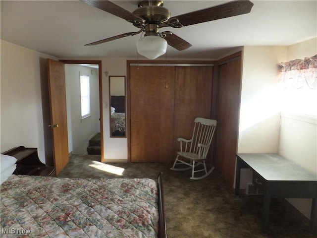 bedroom with a ceiling fan and carpet flooring