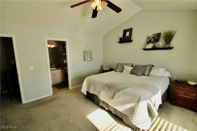 bedroom with connected bathroom, baseboards, light colored carpet, lofted ceiling, and a ceiling fan