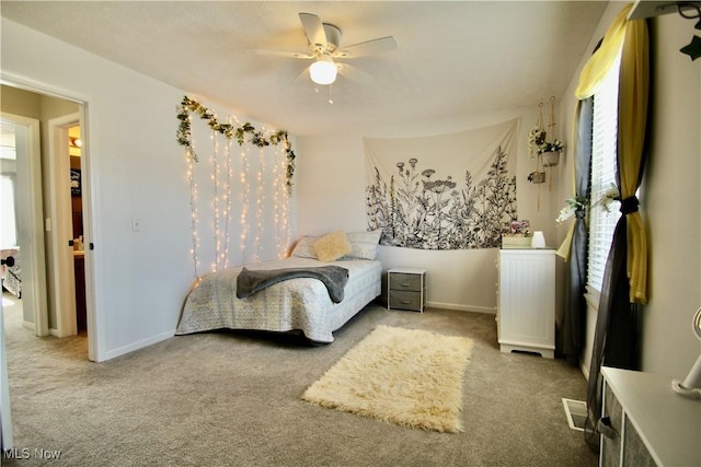 bedroom featuring baseboards, ceiling fan, and carpet floors