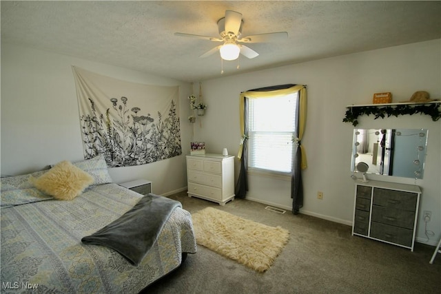 bedroom featuring visible vents, a ceiling fan, a textured ceiling, carpet, and baseboards