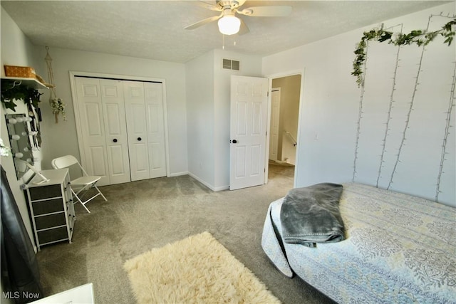 bedroom featuring a closet, carpet flooring, a ceiling fan, and visible vents