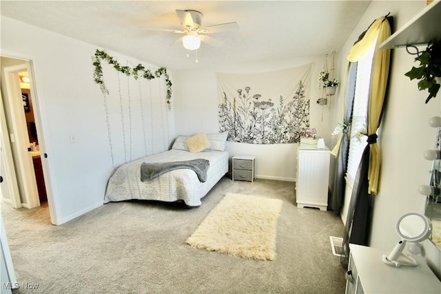 carpeted bedroom featuring ceiling fan and baseboards