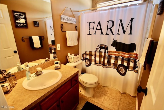 full bathroom with tile patterned flooring, toilet, vanity, and a shower with curtain