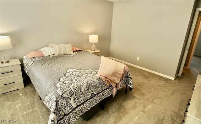 bedroom featuring carpet and baseboards