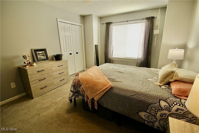 carpeted bedroom with a closet, a textured ceiling, and baseboards