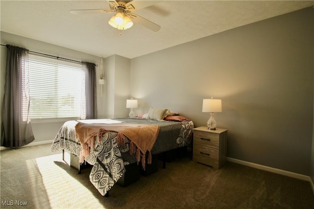 bedroom featuring dark carpet, baseboards, and ceiling fan