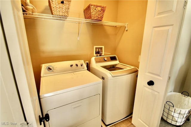 laundry area featuring washing machine and clothes dryer and laundry area