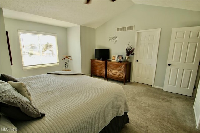 bedroom with visible vents, baseboards, carpet, and lofted ceiling