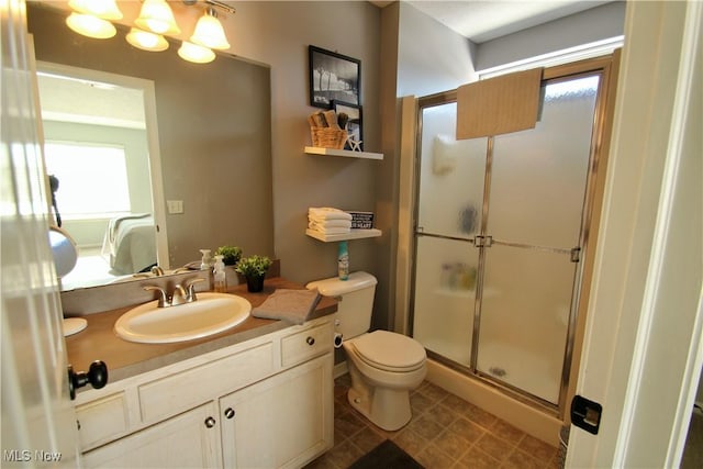 bathroom with toilet, a stall shower, connected bathroom, an inviting chandelier, and vanity