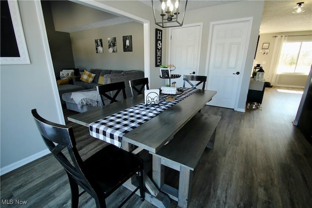 dining room featuring baseboards, a notable chandelier, and dark wood finished floors