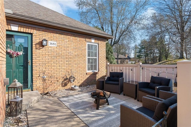 view of patio with an outdoor living space with a fire pit and fence