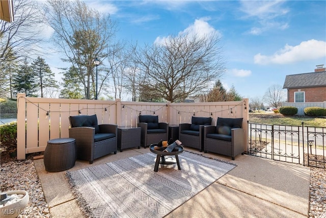 wooden terrace featuring a patio area, an outdoor living space, and fence