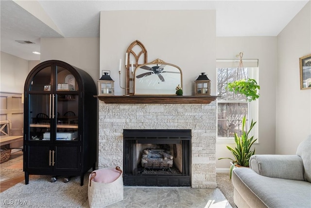 living area featuring visible vents and a fireplace