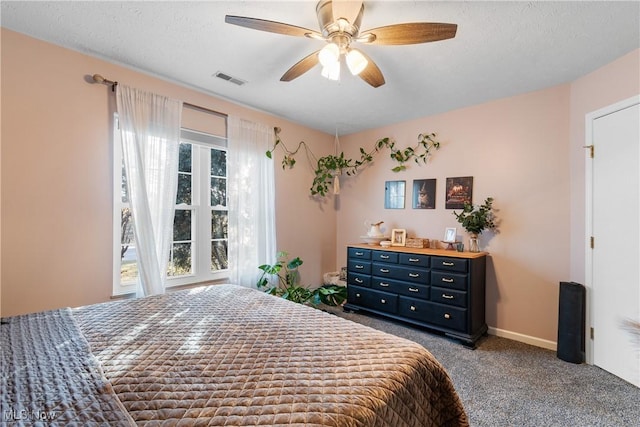 bedroom with visible vents, baseboards, carpet flooring, a textured ceiling, and a ceiling fan