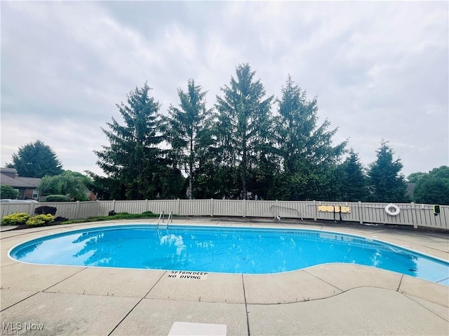 view of swimming pool featuring a fenced in pool, a patio, and fence