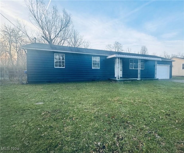 ranch-style house with a garage, driveway, a front lawn, and fence