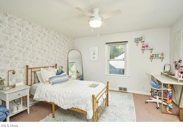 bedroom with visible vents, a ceiling fan, carpet flooring, wallpapered walls, and baseboards