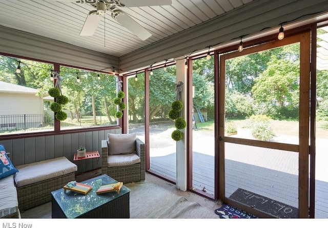 sunroom featuring ceiling fan