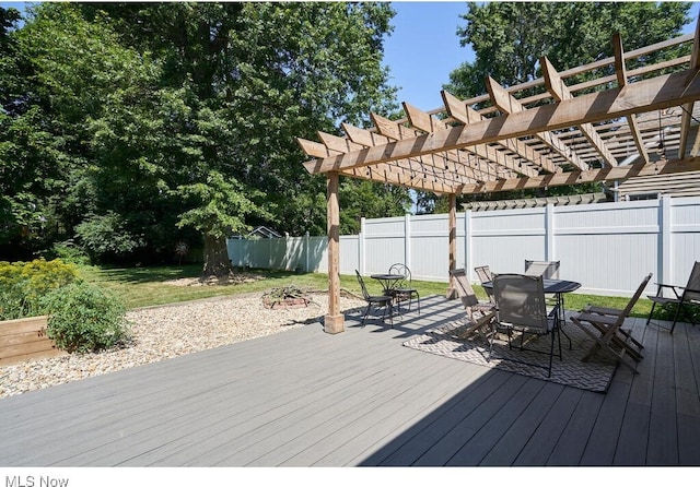 deck featuring outdoor dining space, fence, and a pergola