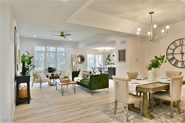 dining space featuring recessed lighting, ceiling fan with notable chandelier, visible vents, and light wood-type flooring