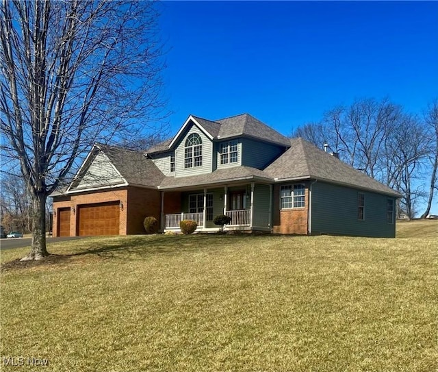 traditional-style house with a front lawn, a garage, brick siding, and covered porch