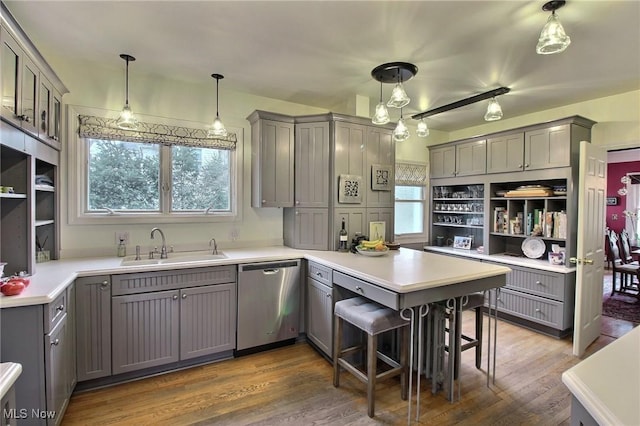 kitchen with dishwasher, open shelves, a peninsula, and gray cabinetry