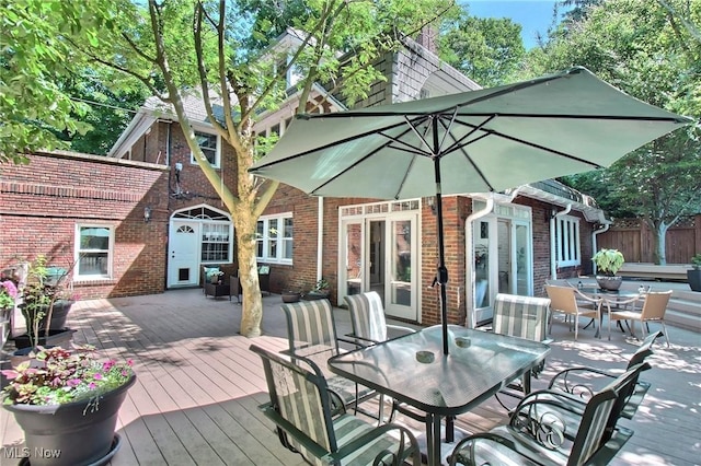 wooden terrace with outdoor dining area