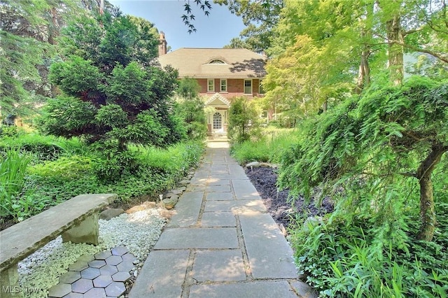 exterior space with brick siding and a chimney