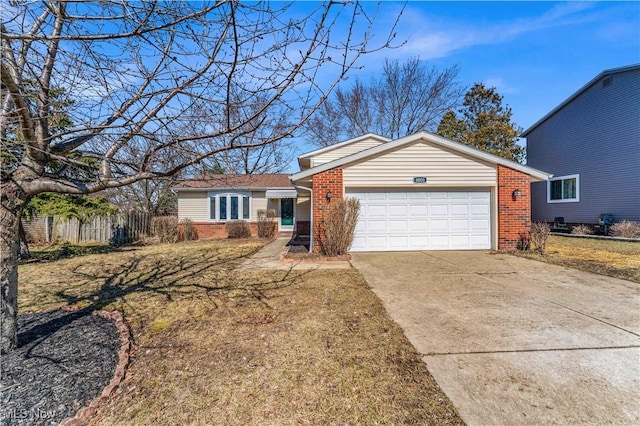 view of front of house featuring a garage, brick siding, driveway, and fence