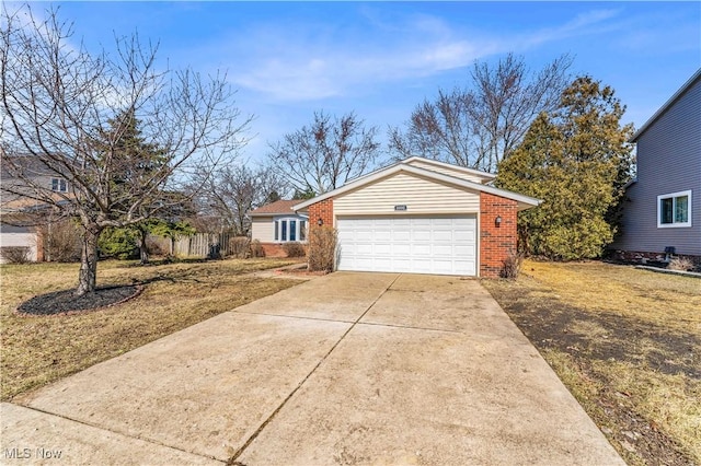 view of front of house featuring a garage, brick siding, and driveway