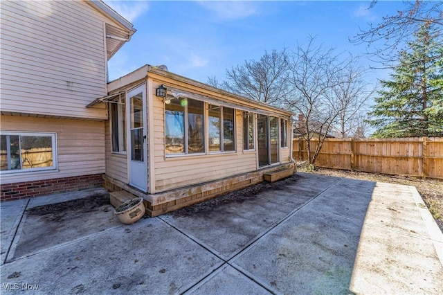 view of side of property featuring a patio and fence