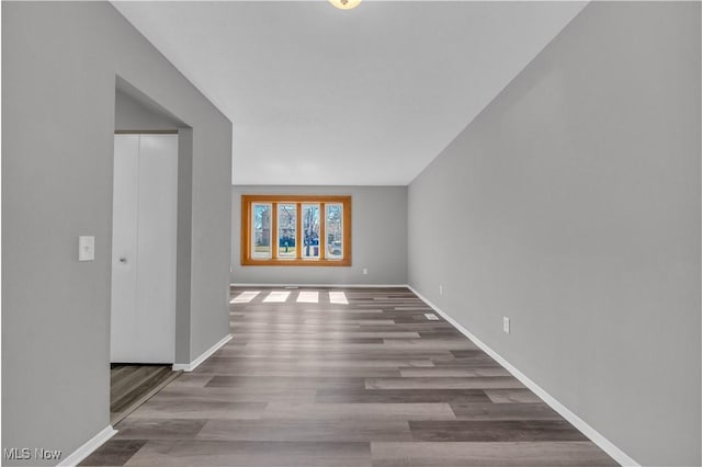 interior space with baseboards and wood finished floors