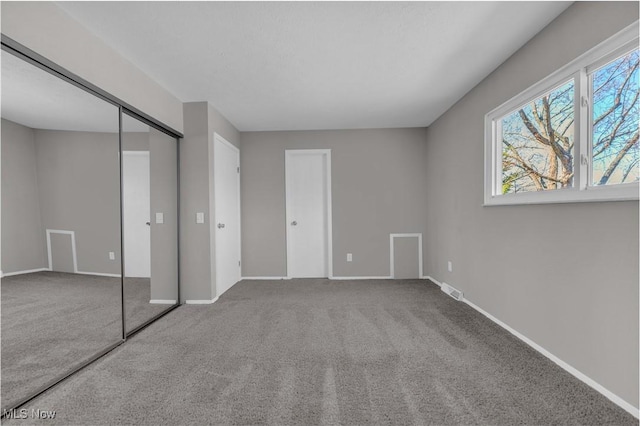 unfurnished bedroom with visible vents, baseboards, and carpet floors